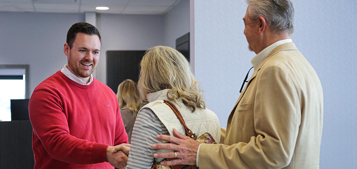 A First Metro Bank employee meeting with customers