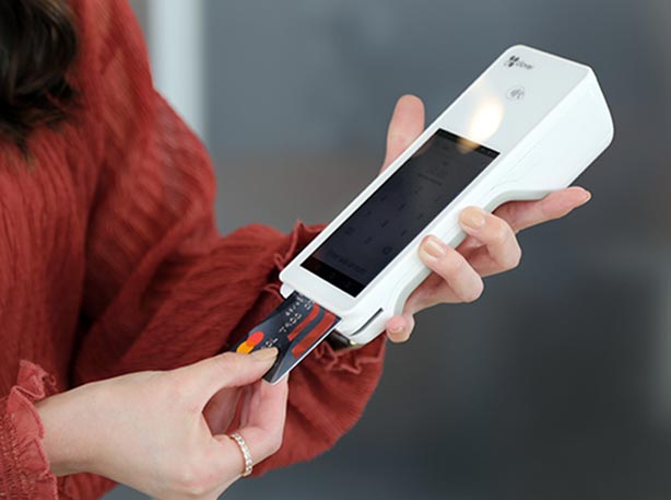 Lady using a portable credit card terminal