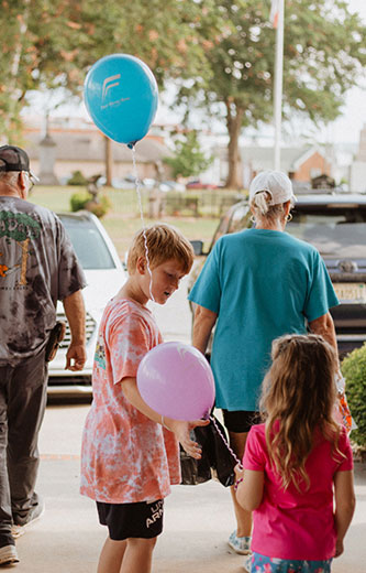A family at a First Metro Bank community event